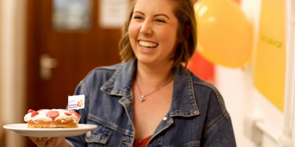 A woman holding two cakes