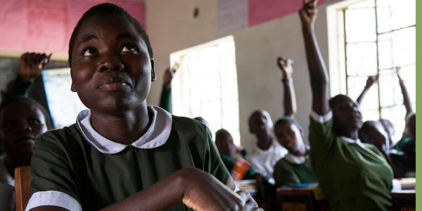 A young African girl participates in a school classroom