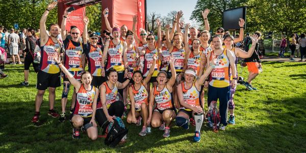 Leonard Cheshire runners celebrate at the end of the London Marathon