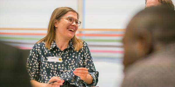 Woman holding a clip board and laughing