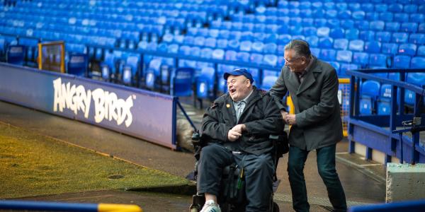 Graham, a volunteer, with Eddie at Goodison Park, home of Everton Football Club