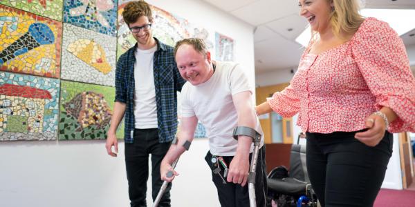 Piers, a physiotherapist, and Harriet, an occupational therapist, with Joe, a resident at Gloucestershire House