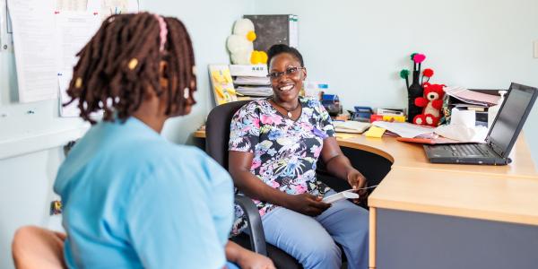 Catherine from Uganda with a colleague at work