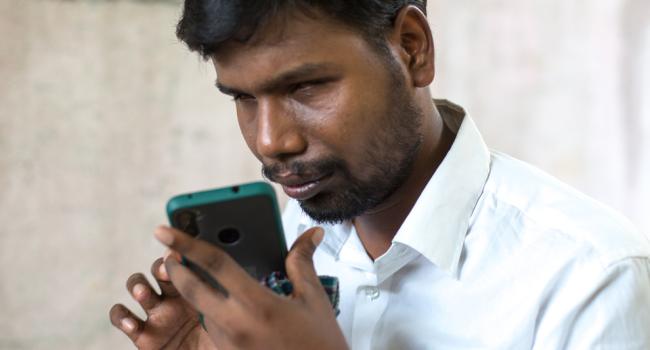 Venkatesh using his mobile phone