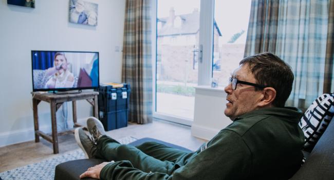 Scott watching tv in his flat