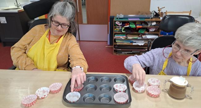 Two female wheelchair users baking