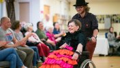 Resident Rebecca Oliver at the fashion show, supported by volunteer Jacob Gamm