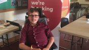 Joshua Reeves in his wheelchair in front of a Leonard Cheshire banner