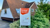 Chipstead Lake sign in front of the exterior of the care home