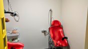 An assisted wet room with red accessibility equipment