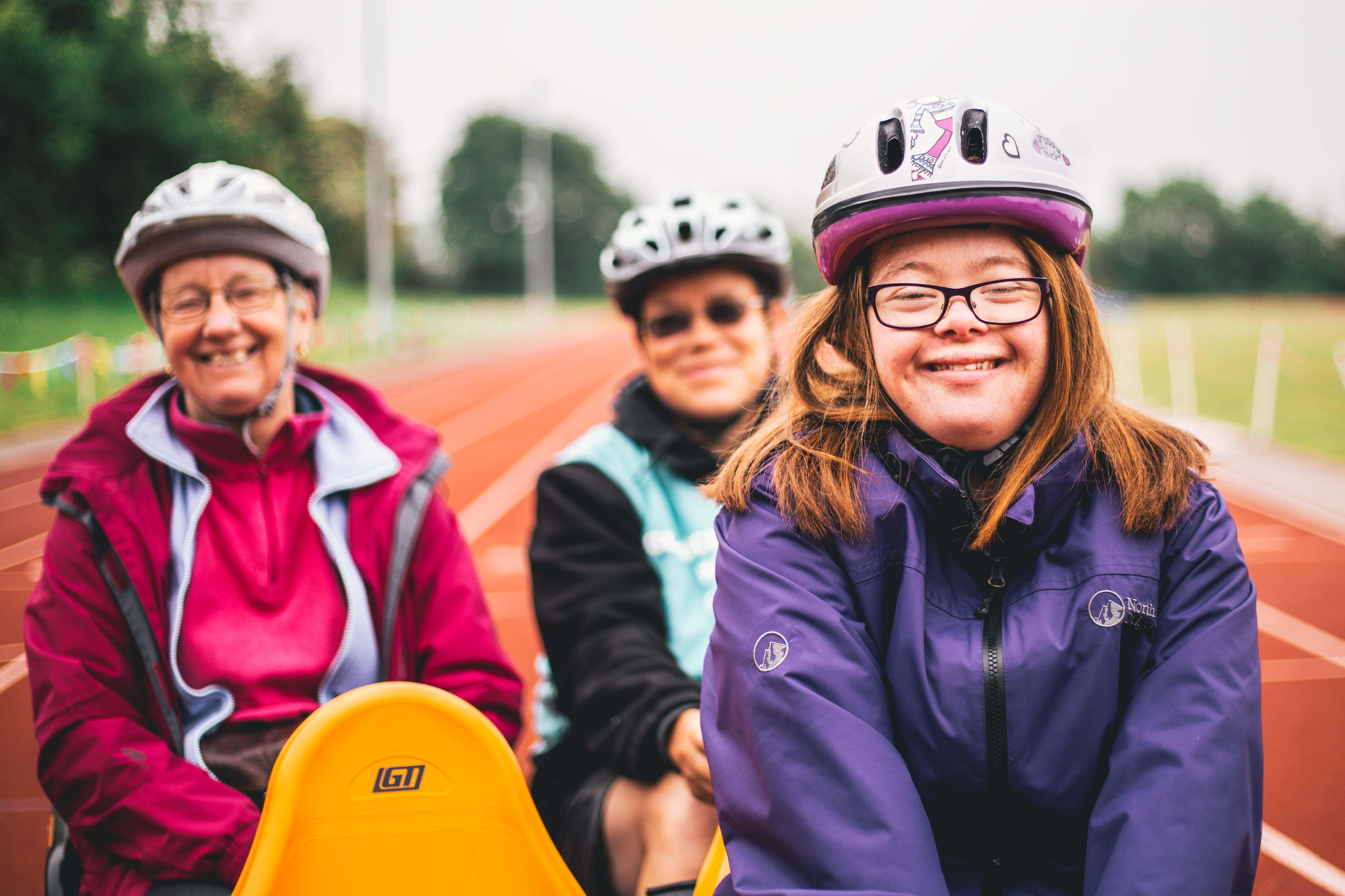 Helen on an adapted bike with two older women behind her