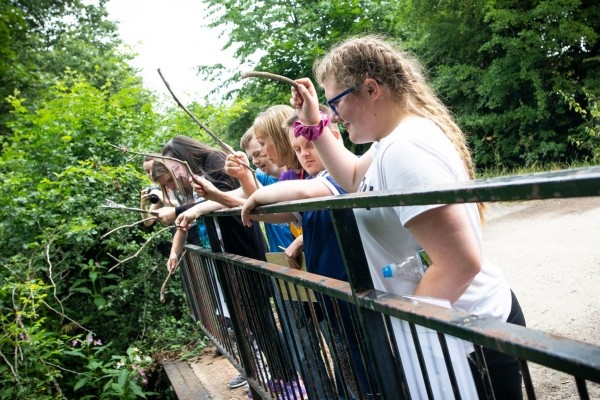 Young people playing on a bridge