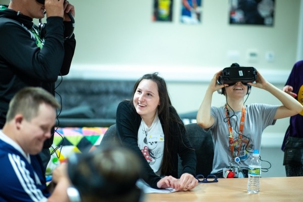 A group of people use VAR headsets in one of our day centre's