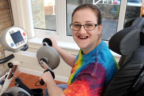 Laura sitting on an exercise bike