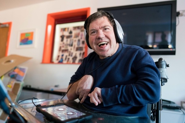 Man using headphones and an ipad