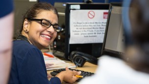 A woman in a day centre learns to use a computer