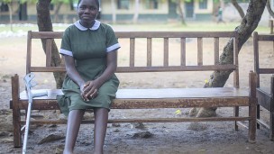 Helen sitting on a bench outside her school