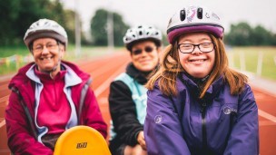 Helen on an adapted bike with two older women behind her