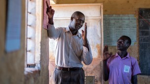 A teacher and pupil in a classroom
