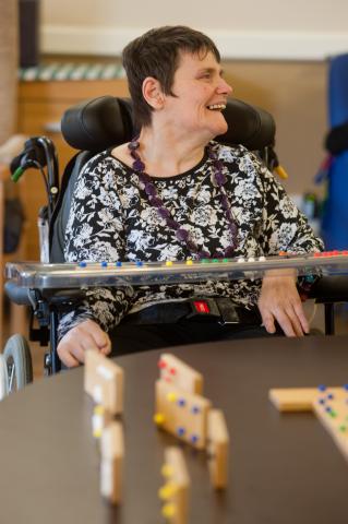 Resident playing dominoes at Dolywern