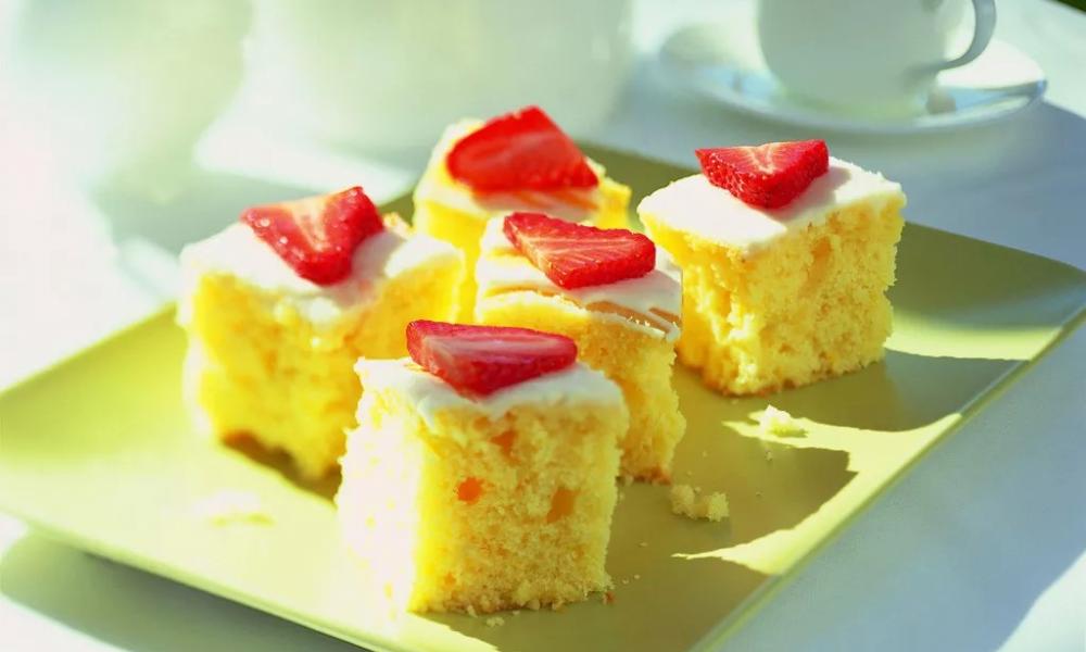Lemon traybakes sit on a plate in a kitchen