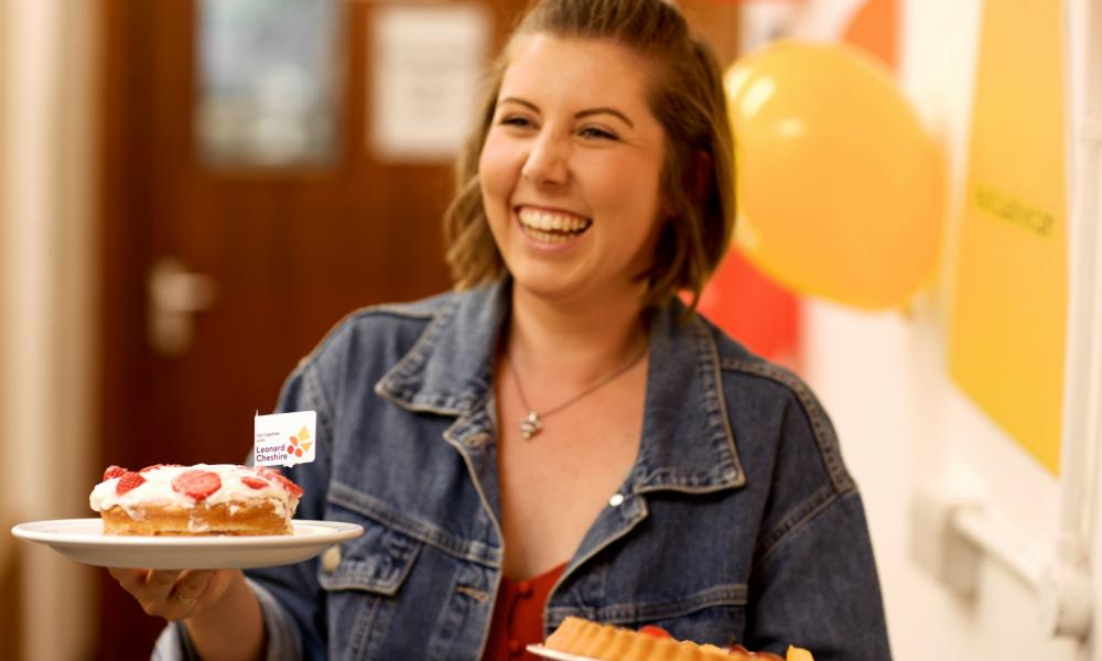 A woman holding two cakes