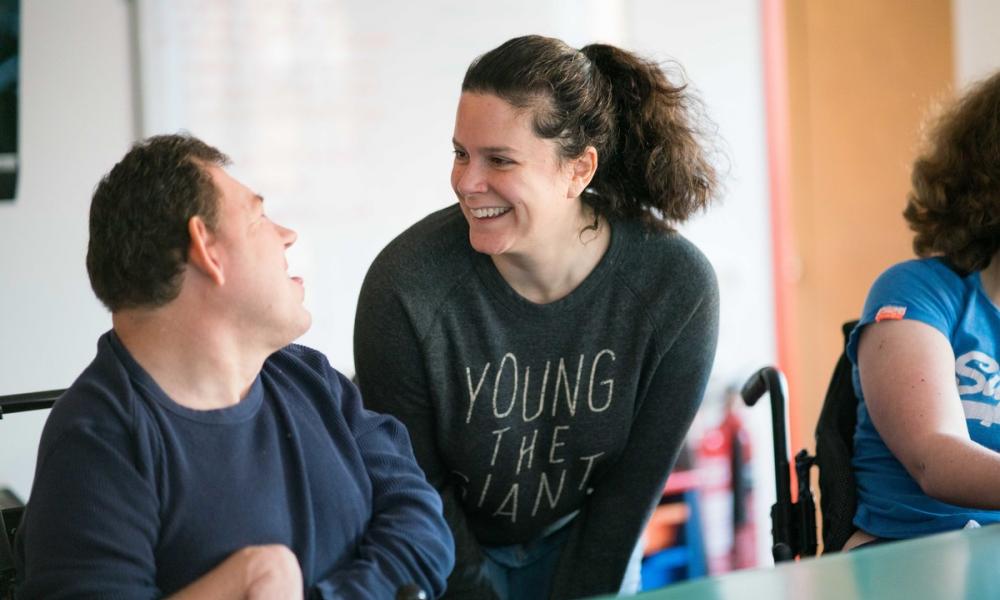 Resident and carer laughing together