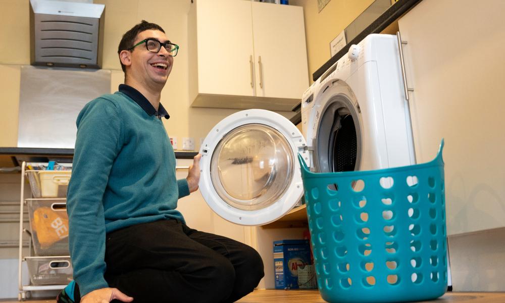 Scott in front of a washing machine