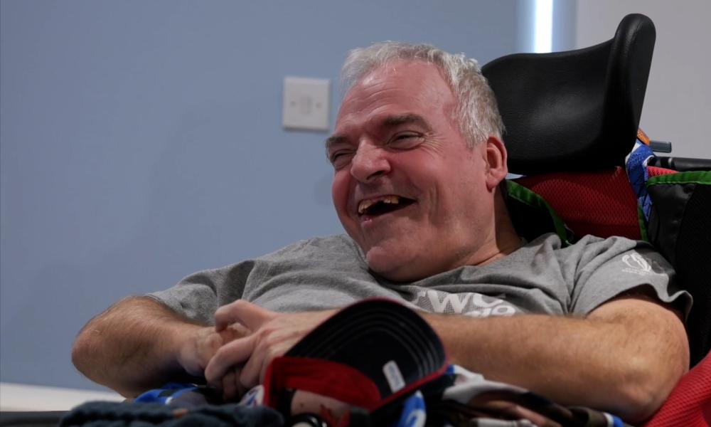 A resident laughing at our assistive tech team
