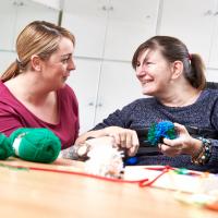 Resident and carer sewing