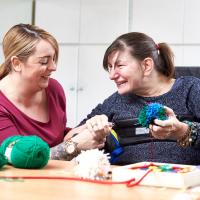 Resident sewing at Greenacres