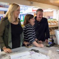 Vicky McQuoid and two other people at a till