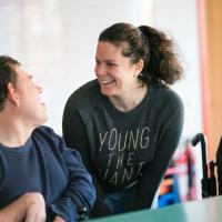Resident and carer laughing together