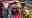 Tori a caucasian female with brown hair braids hugging Tia a blond caucasian female in a field surrounded by crowds of people