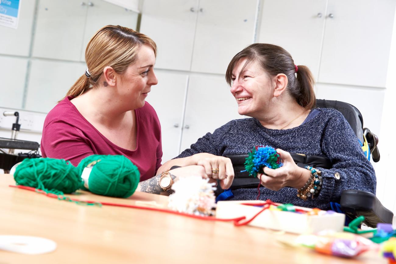 Resident and carer sewing