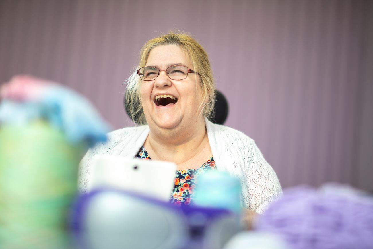 A woman laughing at one of our day centres