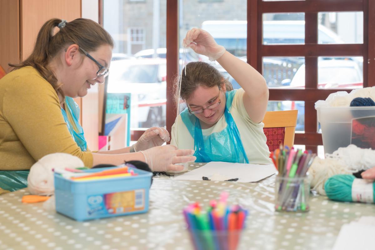 Silvija, a volunteer, with Lynn, a day centre user doing an arts and crafts activity