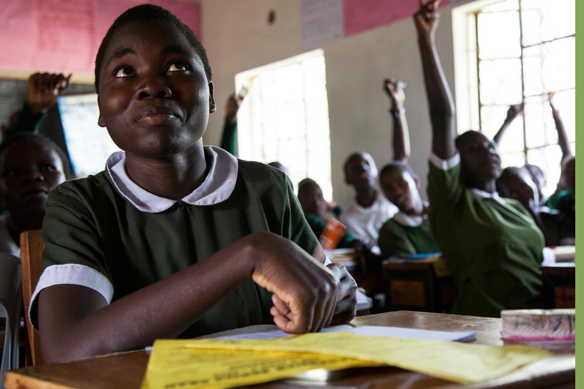 A young African girl participates in a school classroom