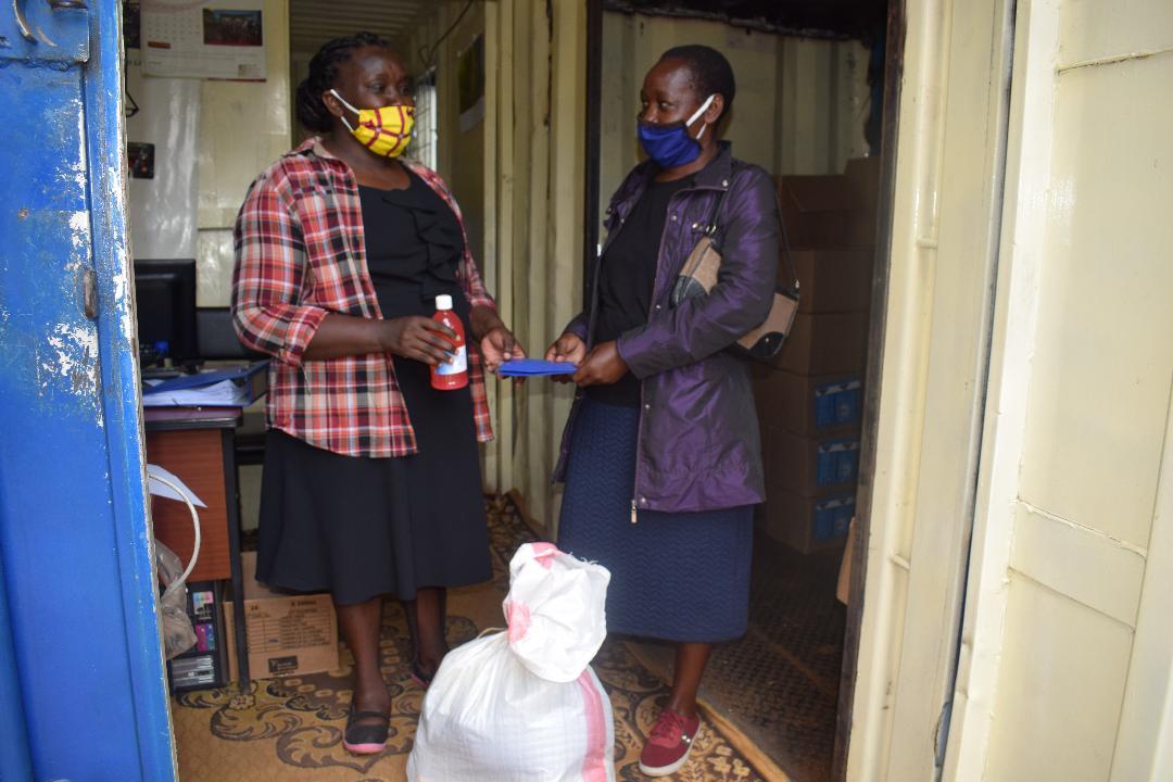 Two women wearing face masks talking