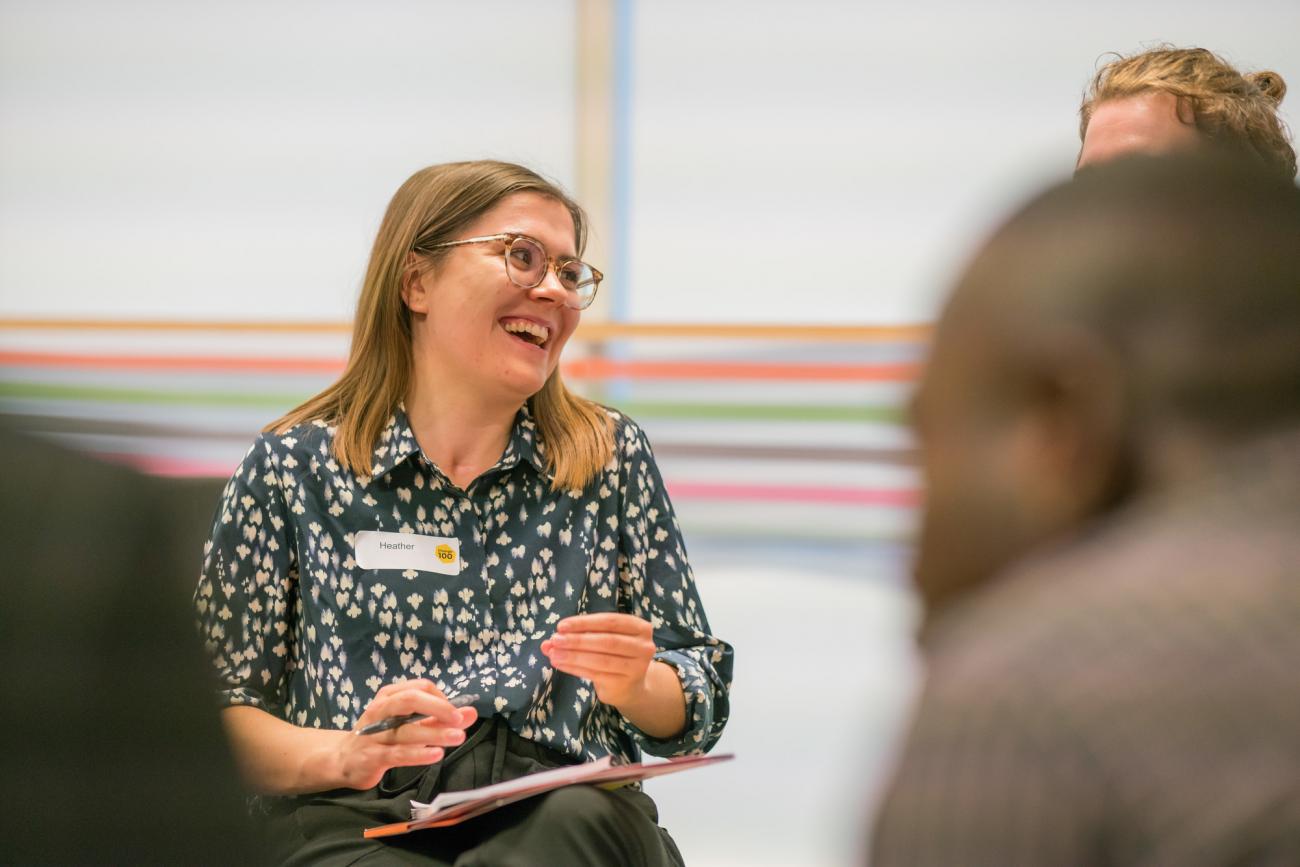 Woman holding a clip board and laughing