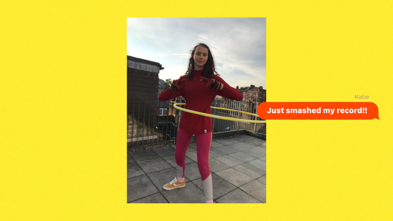 A girl hula hopping with and orange speech bubble saying "Just smashed my record" next to here