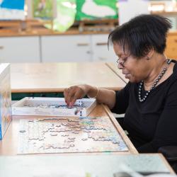 Resident making jigsaw at Heatherley