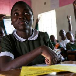 A young African girl participates in a school classroom