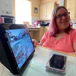 Natalie with Ipad looking at the camera