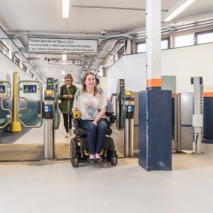 a wheelchair user coming through the barriers