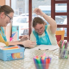 Silvija, a volunteer, with Lynn, a day centre user doing an arts and crafts activity