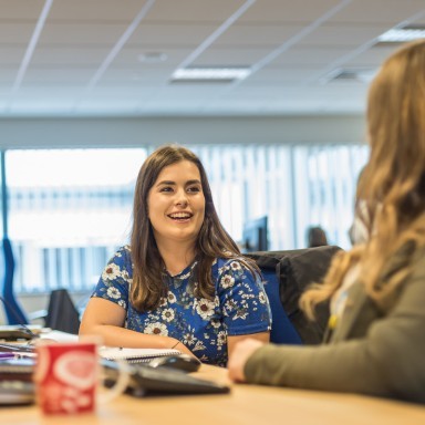 Two women talking in an office