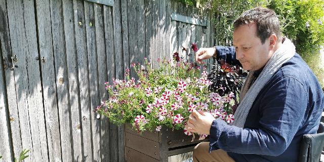 Mark Lane gardening at a raised flower bed