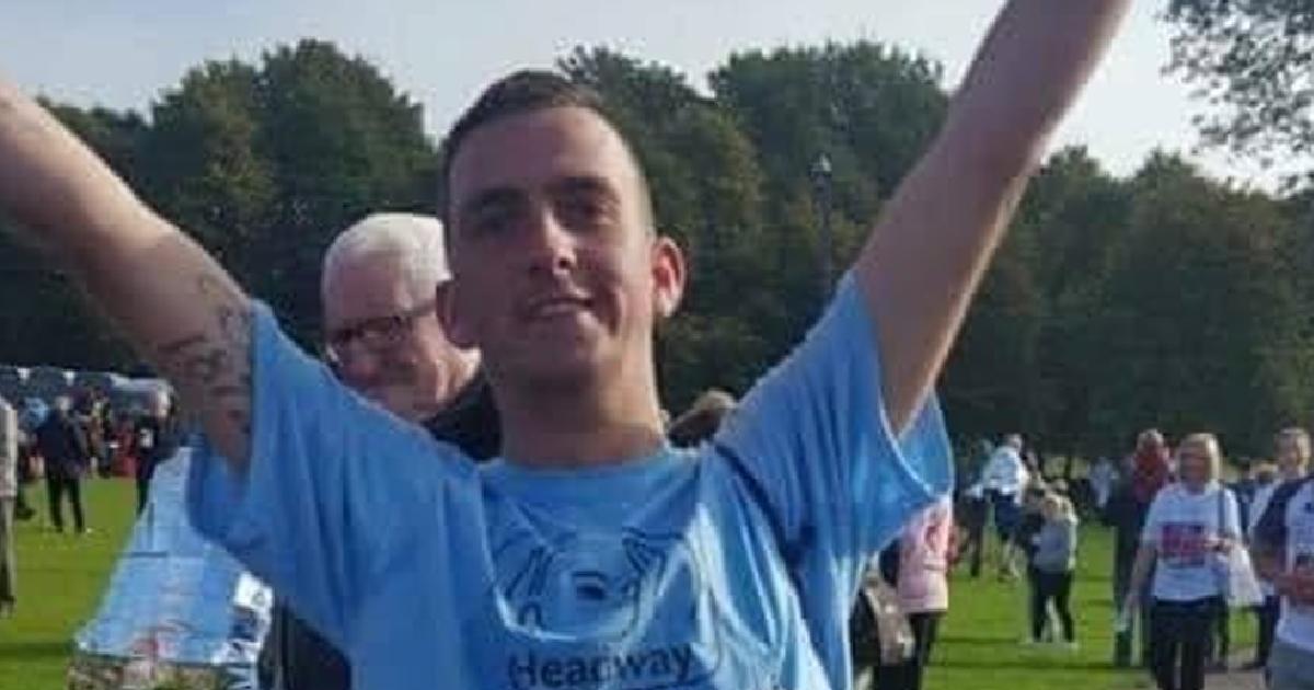 Scott with his hands in the air smiling