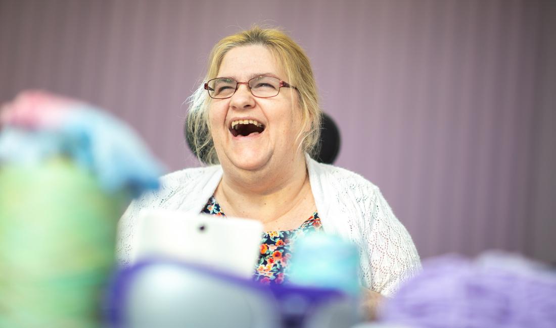 A woman laughing at one of our day centres